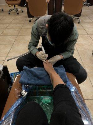 being taken care of by this lovely employee who is really gentle with the pedicure process