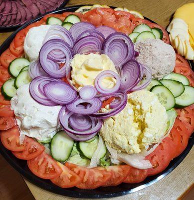 Lox and cream cheese platter with tuna, egg salads and vegetables.