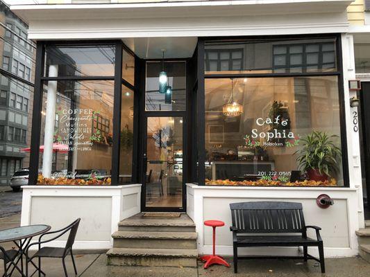 Outside shot of Cafe Sophia, there is outdoor seating as well as indoors