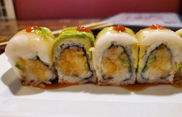 Falls River roll: spicy white tuna, crunch, jalapeno inside; white tuna, avocado outside with spicy sauce.