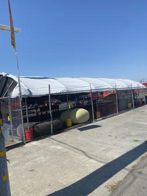 Tented dining area seen from street.