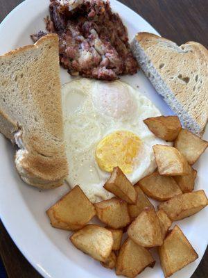 Two eggs over-easy(ish), a tiny (but tasty) side of corned beef hash, and (compared to other pics) a diminutive side of potatoes