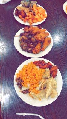 Chinese food. Fried dumplings, fried rice, chicken wings, mushrooms, chicken on a stick, shrimp, clams.