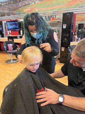 getting his hair cut.