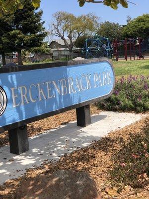 Signage with playground in rear