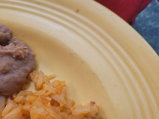 The gray about the rice looks like dirt or grime. You could smear it with your finger.