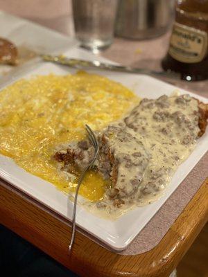 Country fried chicken and grits with cheddar cheese and fried eggs.