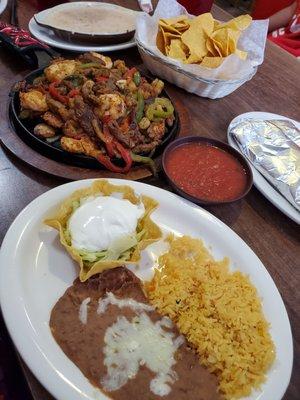 Fajitas, salsa, bean dip, and chips