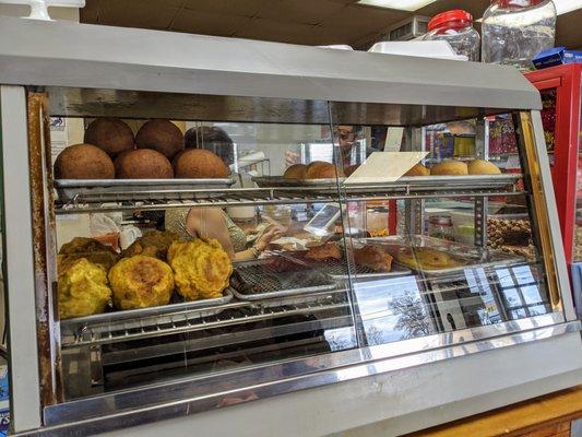 Ready-made hot item display 2 of 2. Not sure what these were. Croquettas, perhaps? Blood sausage, empanadas, some sort of breads/rolls.