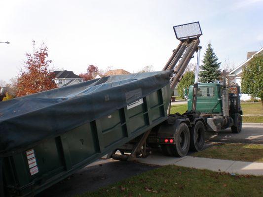 20 yard dumpster rolling off truck.