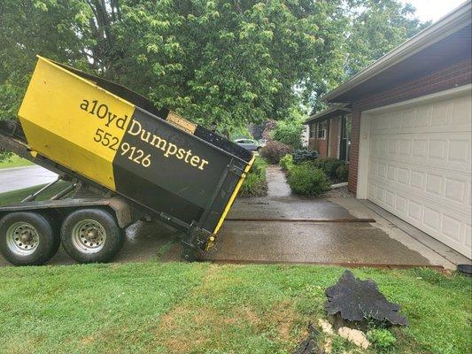 10yd Dumpster sat on boards to protect the driveway