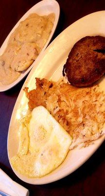 Sausage patty and eggs with biscuits and gravy.