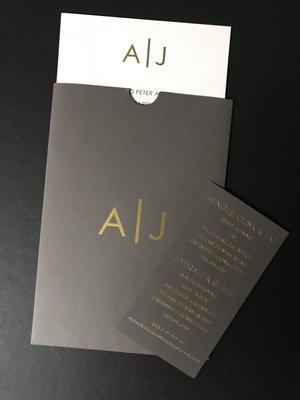 Gold Foil on charcoal pocket with invitation in letterpress printing; details card in gold foil stampng