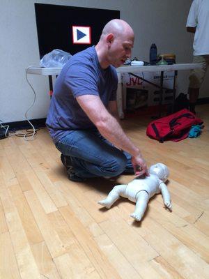 Josh instructing infant CPR.