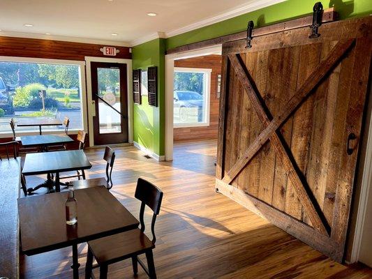 Seating in front and entrance to grassroots creamery on right through sliding door