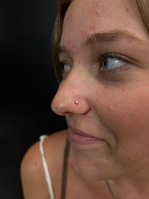 Nostril piercing using implant grade titanium by Ash, @fairywithaneedle