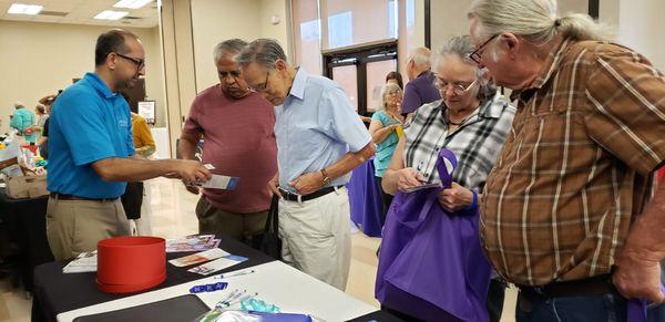 Seniors visiting Life Foundation Home Care booth at Fort Bend Seniors event