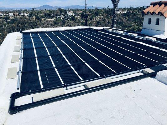 Flat roof custom solar pool heating system. With these panels, you don't have to worry about freeze damage!