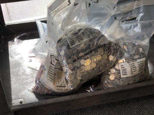 Friday, May 31, 2019: money!!! Credit union employee is emptying the coin machine.