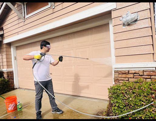 Pressure washing the house.