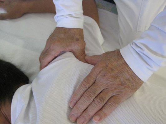 Using thumbs and fingers for Shiatsu Therapy.