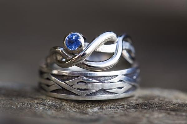 Female/Male Wedding bands- designed from a theme of "three strands." White Gold and sapphire for the bride. Silver for the groom.