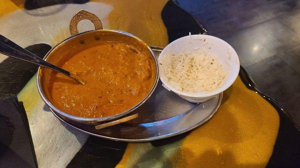 Butter chicken (half eaten). Not spicy at all.