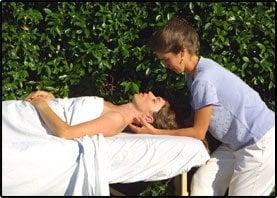 Kristin of PHL giving an outdoor massage demonstrating her strategic Whiplash rehabilitation healing neck bodywork.