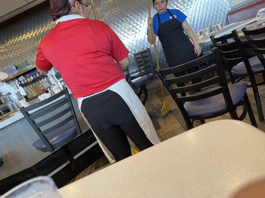 Mopping the floors while eating.