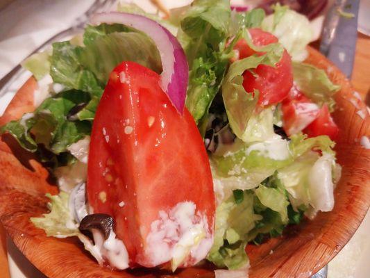 Side Salad with lettuce, tomato, black olives, purple onion, and their home Italian dressing with parmesan cheese