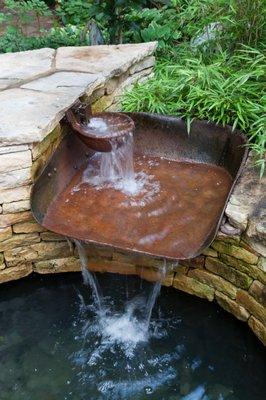 Shabby-chic backyard fountain and pond (design by Christie Dustman & Co.)