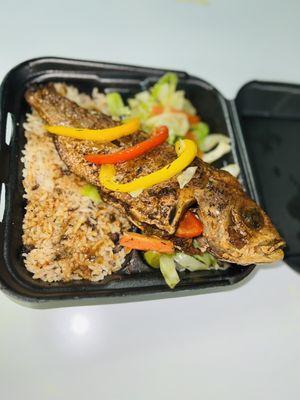 Escovitch Fish on a bed of Cabbages served along with Rice and Peas