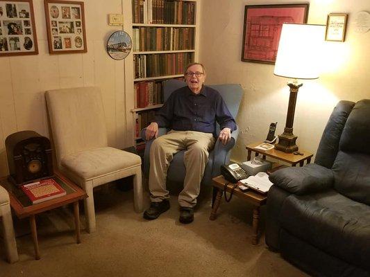 Happy senior in clean living room.