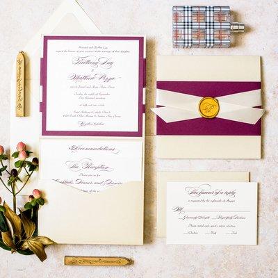 A burgundy and champagne pocket wedding invitations complimented with a traditional wax seal.