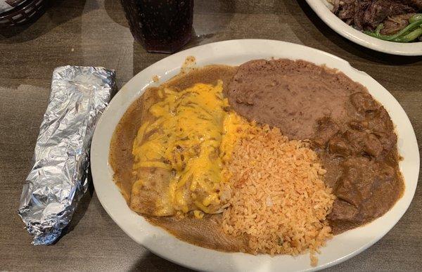 Chicken enchiladas, Carne Guisada, Rice, and Beans.