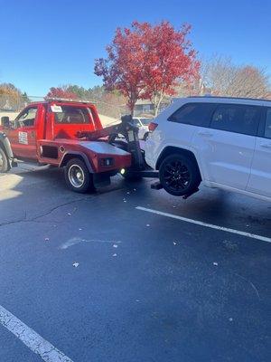 My jeep attached to the tow truck.