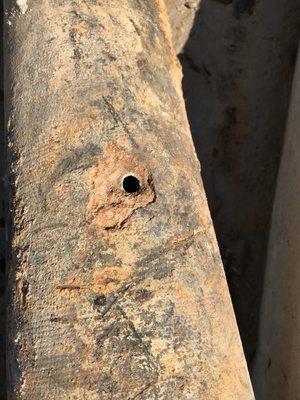 Hole in fire sprinkler system pipe that was under ground at a local grocery store.