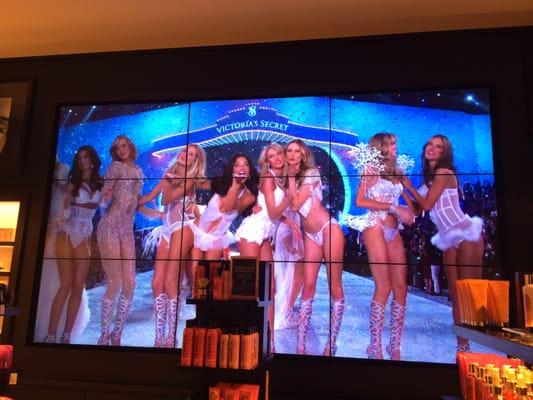 Huge screens play the latest VS Fashion Show.