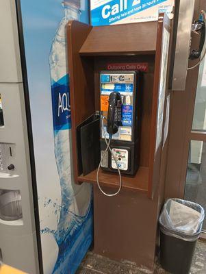 Payphone just inside the front doors.