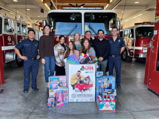 Spreading holiday cheer at the local fire department for Spark of Love Holiday Toy Drive!