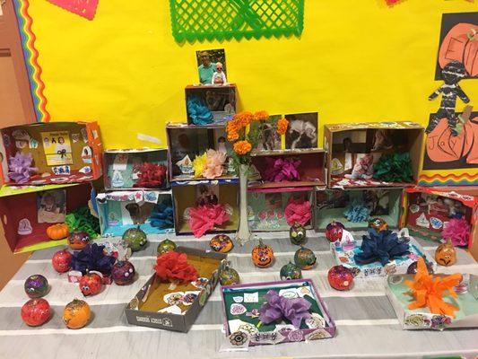 Dia de los Muetos altars from the Transitional Kindergarten class. There is art inside and outside of the classroom.