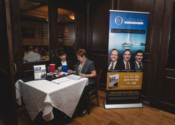 Checking in is easy at one of the monthly educational workshops hosted by Outlook Wealth Advisors.