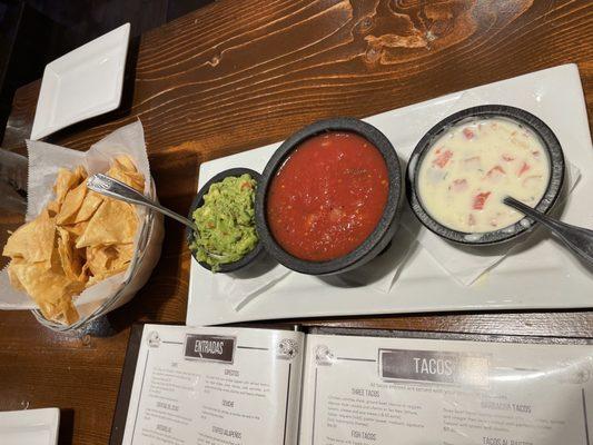 Chips, guacamole, salsa, and queso dip