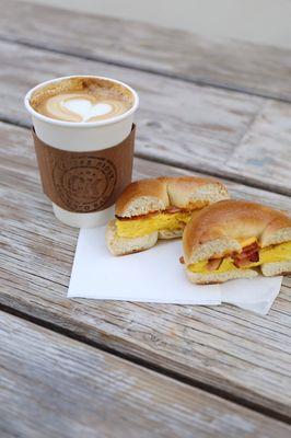 Egg, bacon, and cheese bagel sandwich, followed by a latte made with lots of love.