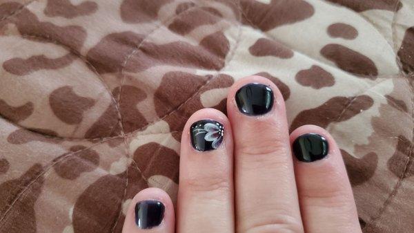 Beautiful butterfly/flower design on black gel manicure.