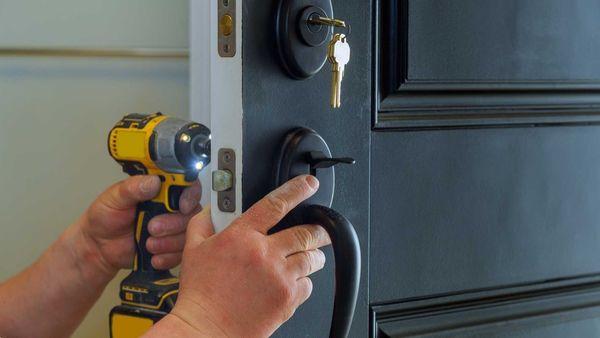 Technician from Alexander's hardware working on the lock