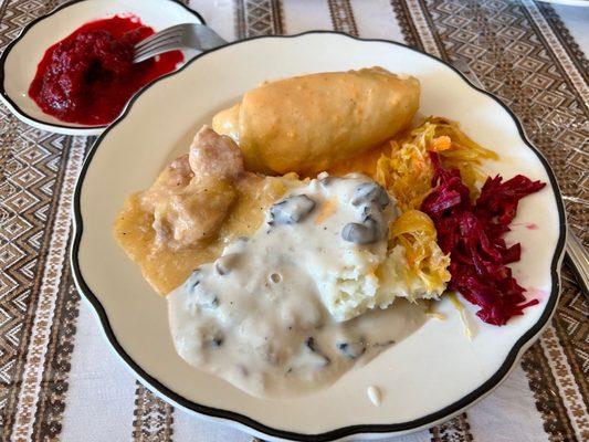 Buffet items; stuffed cabbage, mushroom gravy over mashed potatoes, pork stew, cabbage and beets.