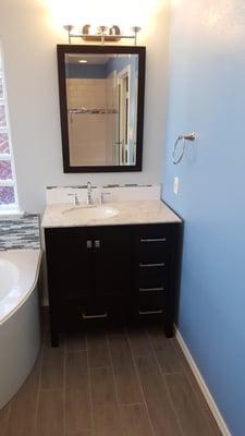 New vanity with custom back splash, new mirror and new lighting.