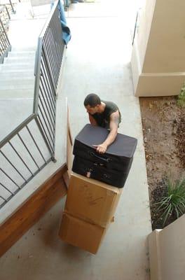 Lorenzo moving some boxes and luggage.