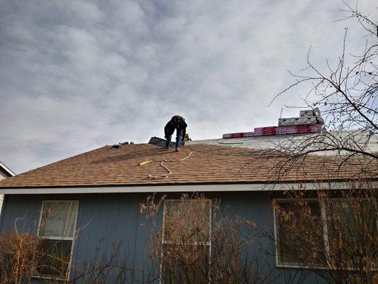 Our 1 worker putting down the new shingles.